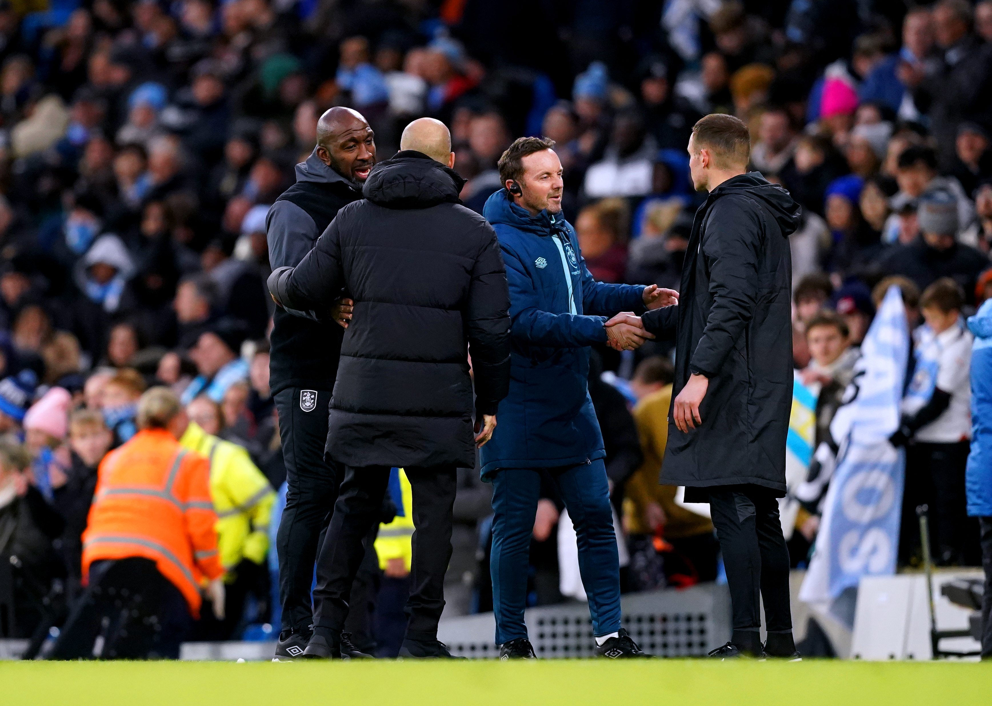 Darren Moore, left, speaks to Pep Guardiola after the game