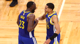 Jordan Poole and Draymond Green of the Golden State Warriors celebrate against the Boston Celtics in the NBA Finals