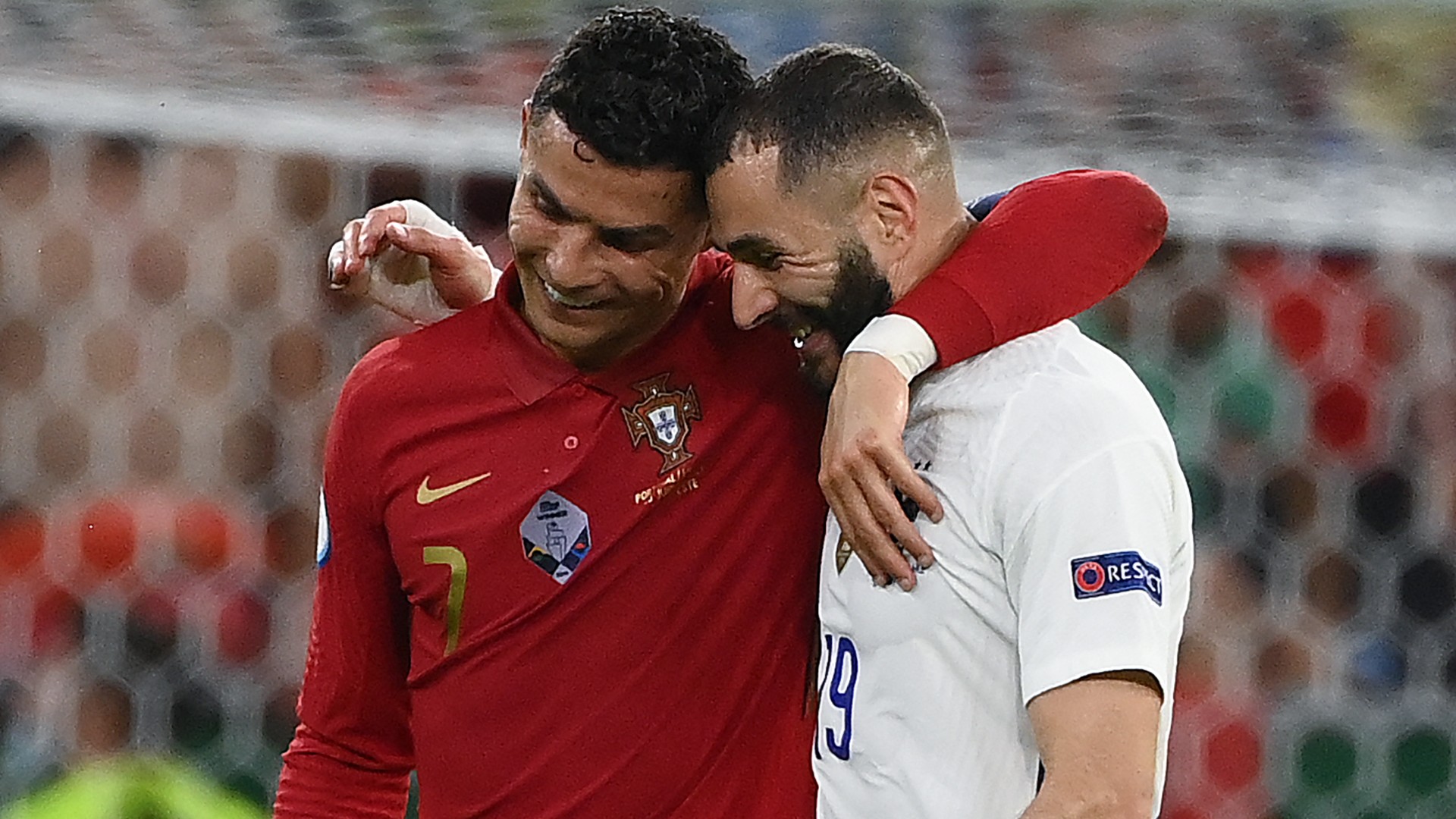 Cristiano Ronaldo and Karim Benzema embrace having scored braces in Budapest.