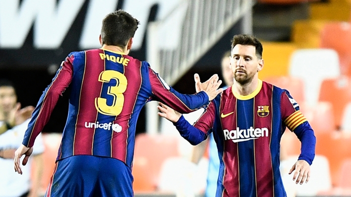 Gerard Pique and Lionel Messi celebrate during Barcelona's win at Valencia