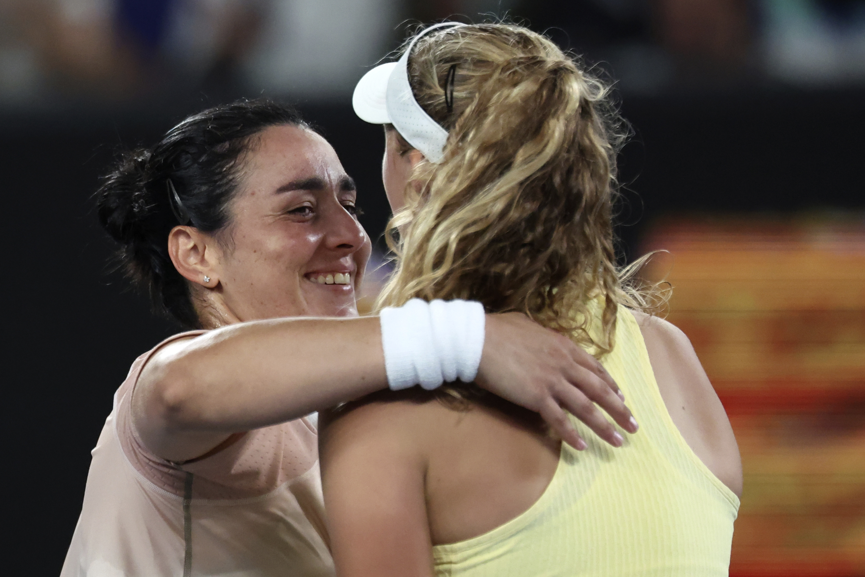 Mirra Andreeva, right, is congratulated by her idol Ons Jabeur