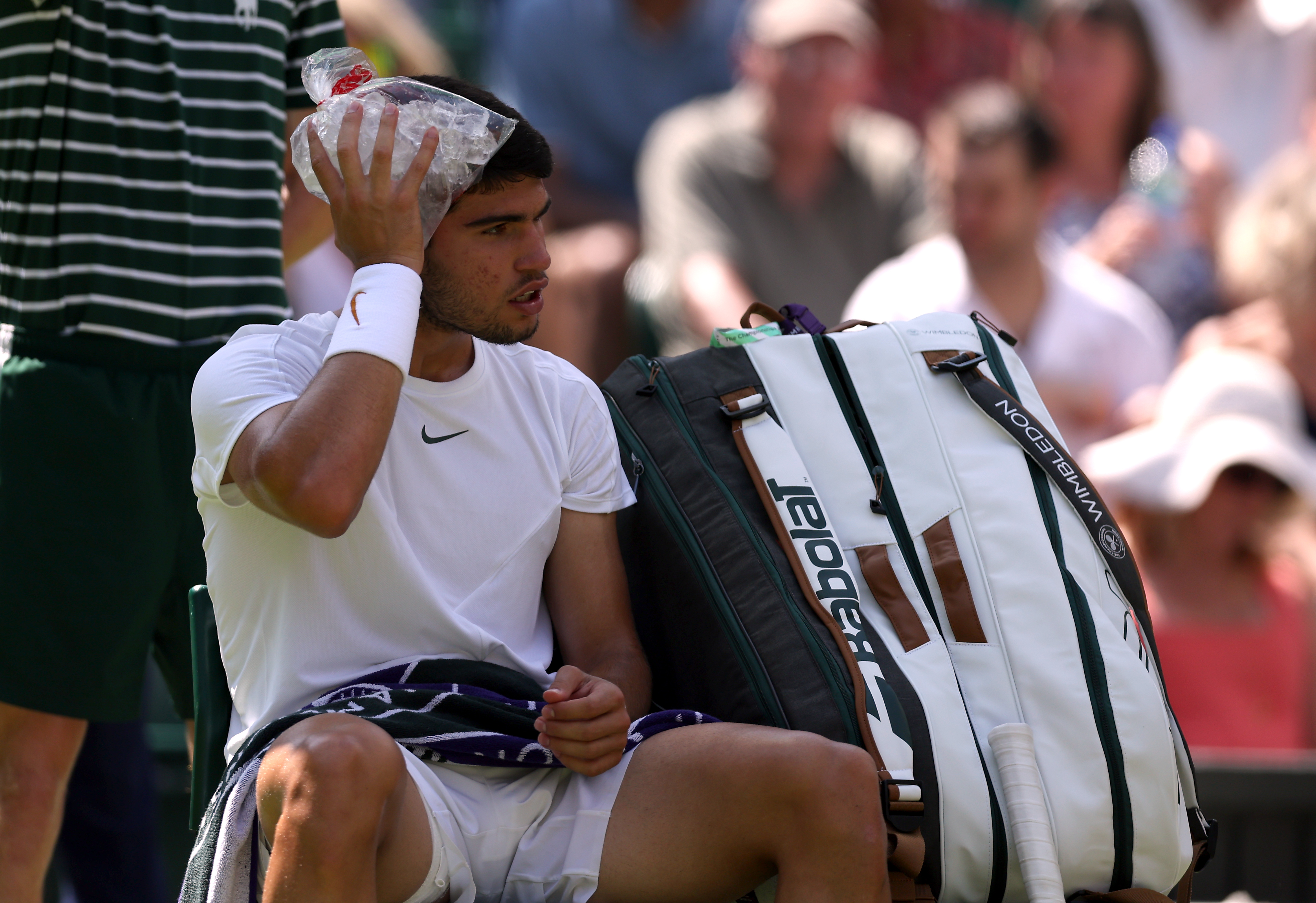 Carlos Alcaraz cools himself down with a bag of ice