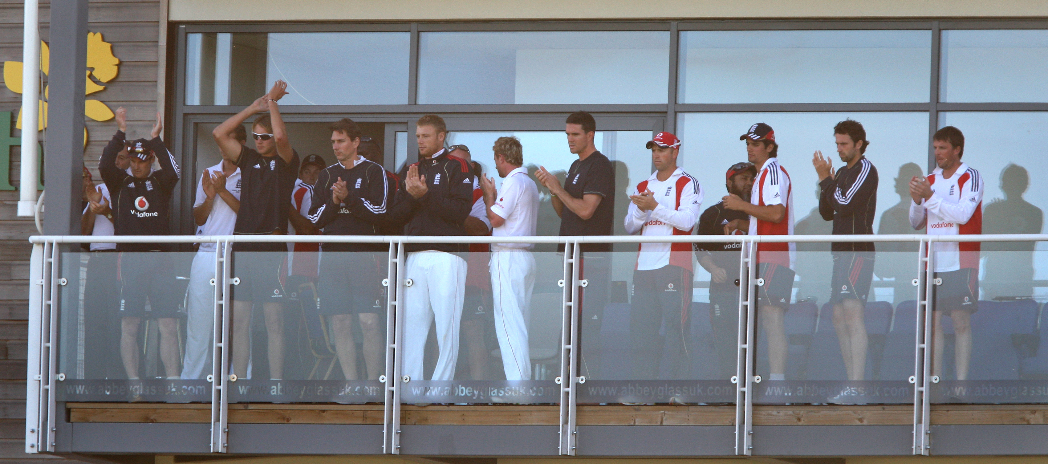 England captain Andrew Strauss (left) leads the rest of the players in applauding James Anderson and Monty Panesar off the pitch after they bat time out on final day to earn a draw in the first Ashes Test