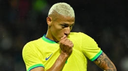 Brazil striker Richarlison kisses the badge on his shirt after scoring against Ghana