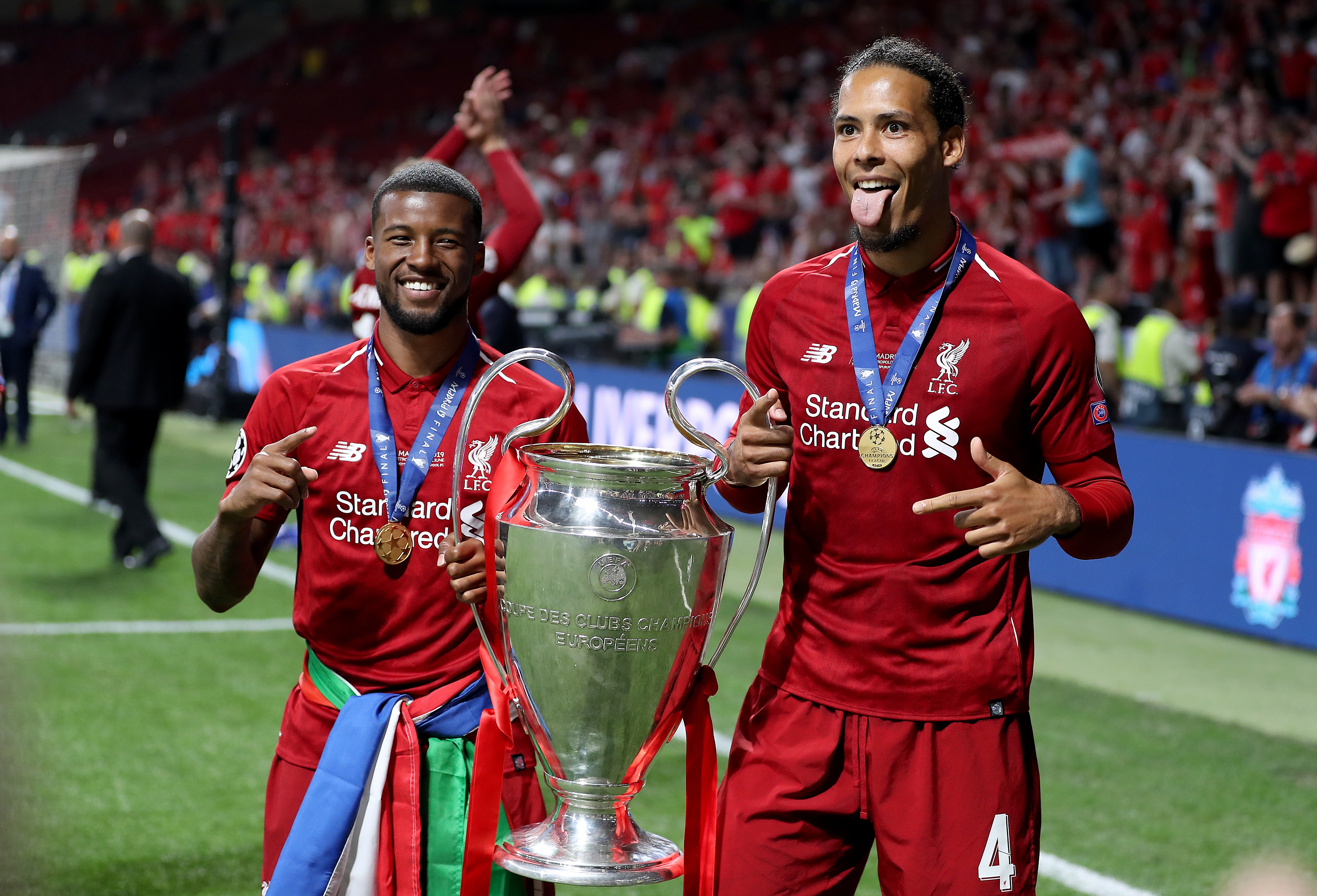 Virgil van Dijk, right, and Georginio Wijnaldum celebrate with the Champions League trophy