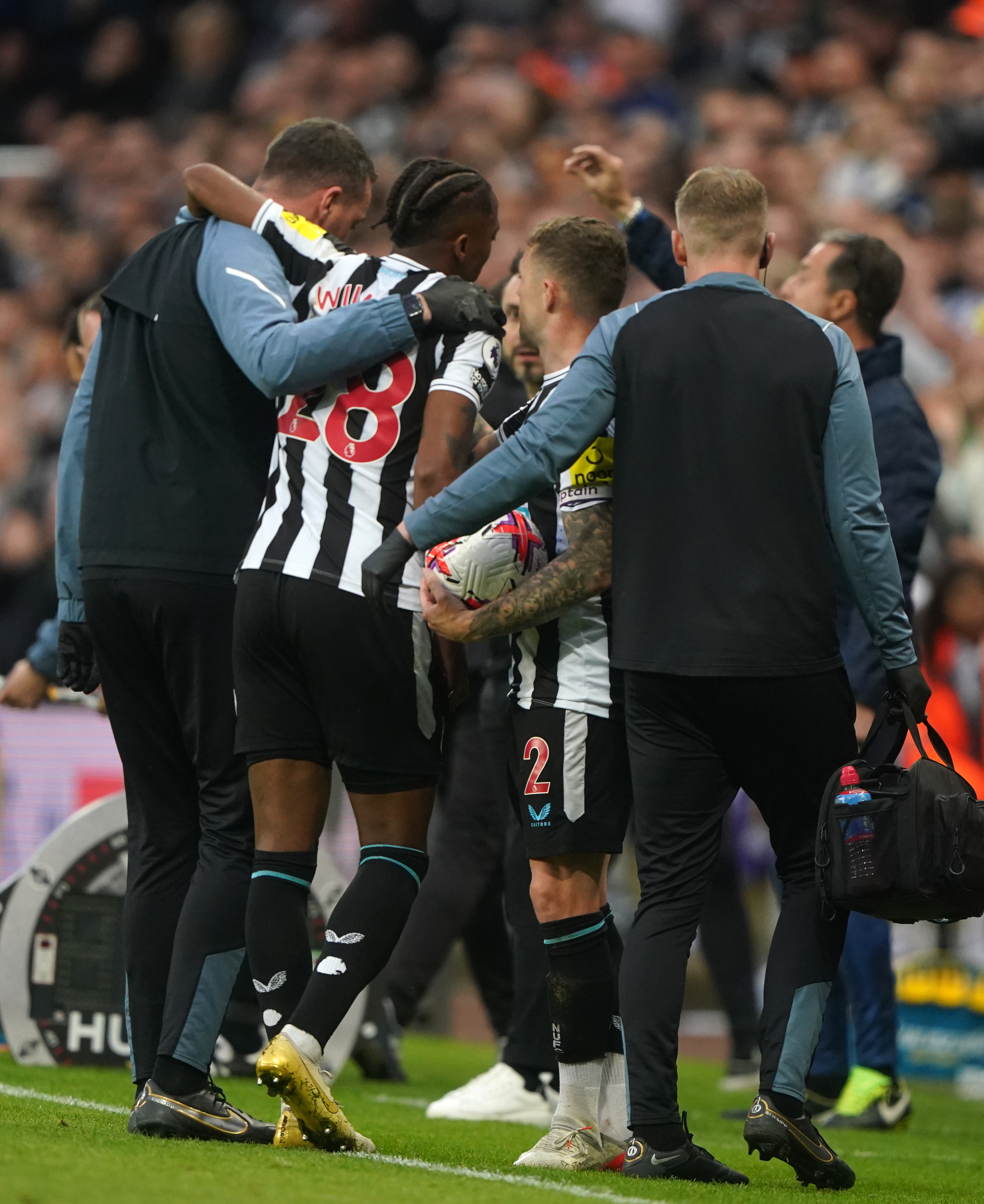 Newcastle midfielder Joe Willock leaves the pitch with an injury
