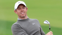 Rory McIlroy watches the flight of his second shot to the eighth hole, which found the hole for an eagle