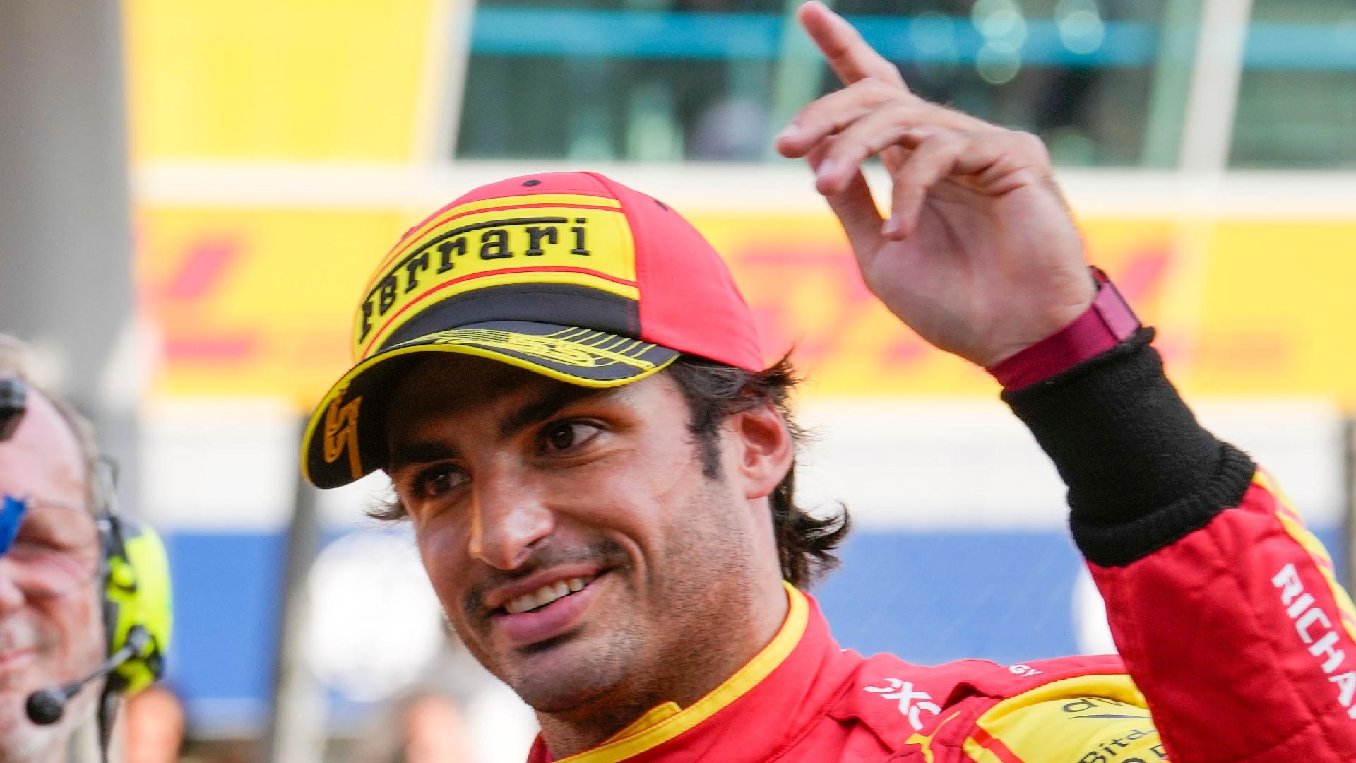 Ferrari driver Carlos Sainz of Spain, right, celebrates his pole position (Luca Bruno/AP)