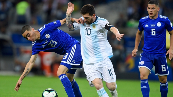 Lionel Messi tussles with Miguel Almiron