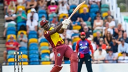 Rovman Powell hits a six for West Indies against England in a T20I at the Kensington Oval