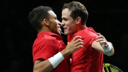 Felix Auger-Aliassime (L) and Vasek Pospisil chest-bump after leading Canada into the Davis Cup final