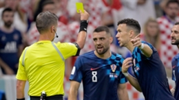 Mateo Kovacic is shown a yellow card for dissent by Daniele Orsato during Croatia's defeat to Argentina
