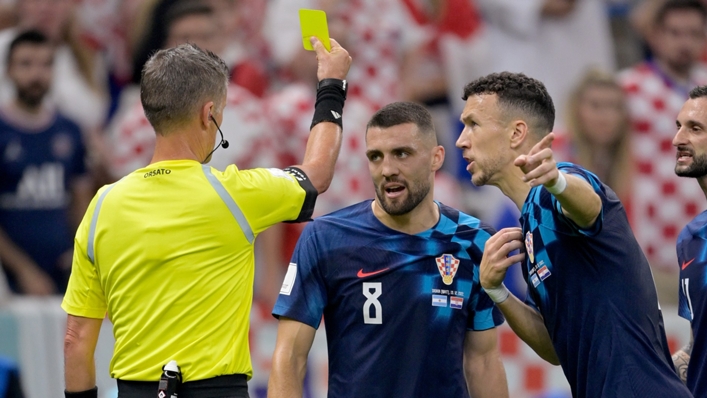 Mateo Kovacic is shown a yellow card for dissent by Daniele Orsato during Croatia's defeat to Argentina
