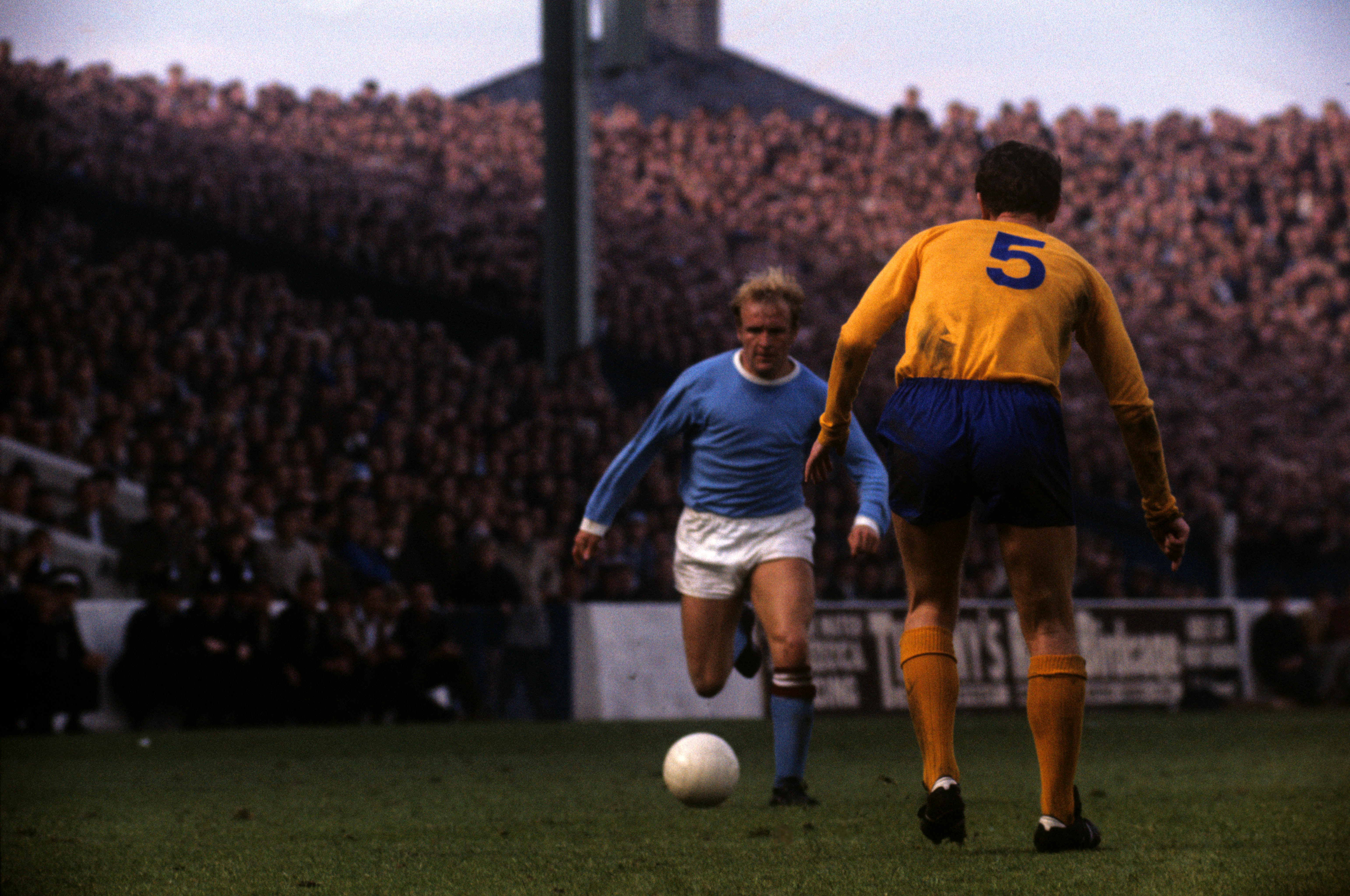Francis Lee runs at Everton defender Brain Labone