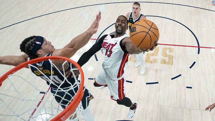Miami Heat center Bam Adebayo is defended by Denver Nuggets forward Aaron Gordon (Mark J. Terrill/AP)