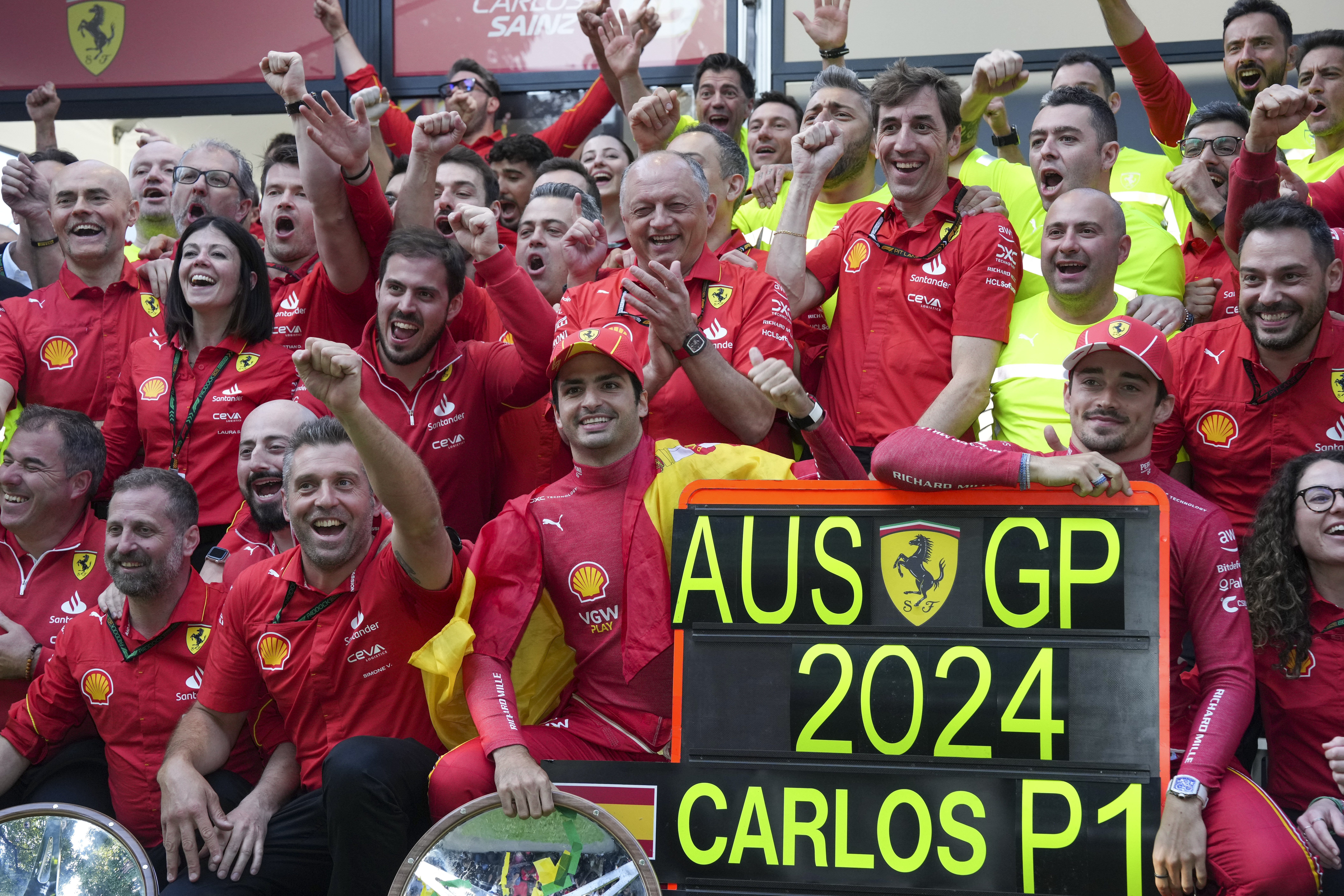 Ferrari team celebrate the race win of Carlos Sainz, centre, of Spain and second placed Charles Leclerc