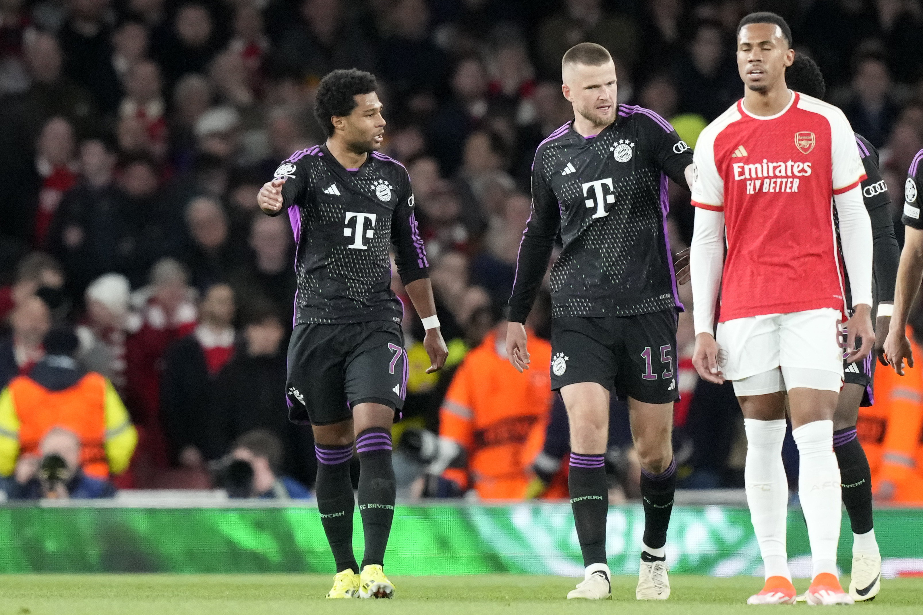 Bayern Munich’s Serge Gnabry, left, celebrates his goal as Arsenal's Gabriel, right, shows his frustration