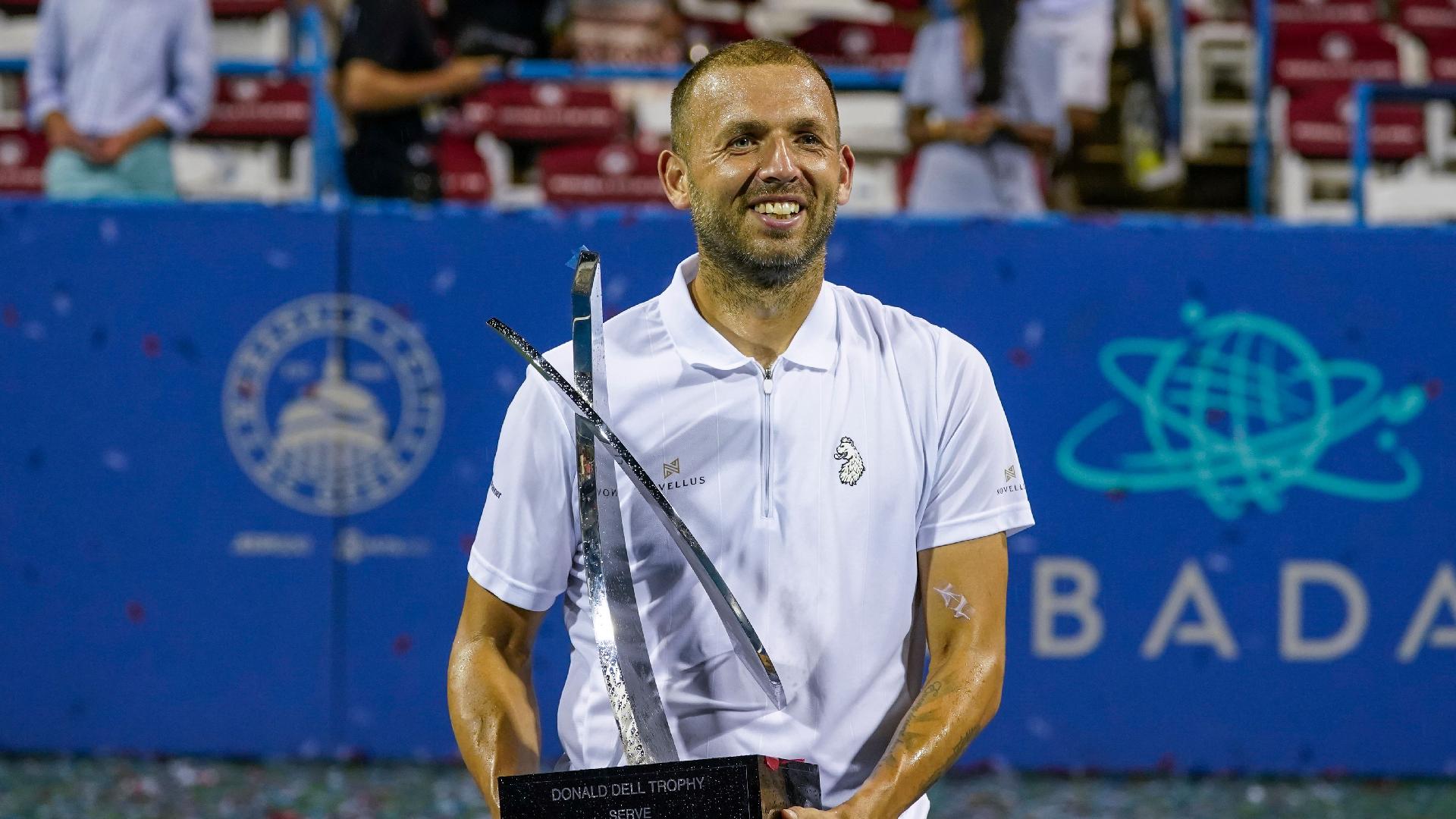 Daniel Evans, of Britain, holds the trophy after defeating Tallon Griekspoor in the men’s singles final of the Citi Open (Alex Brandon/AP)