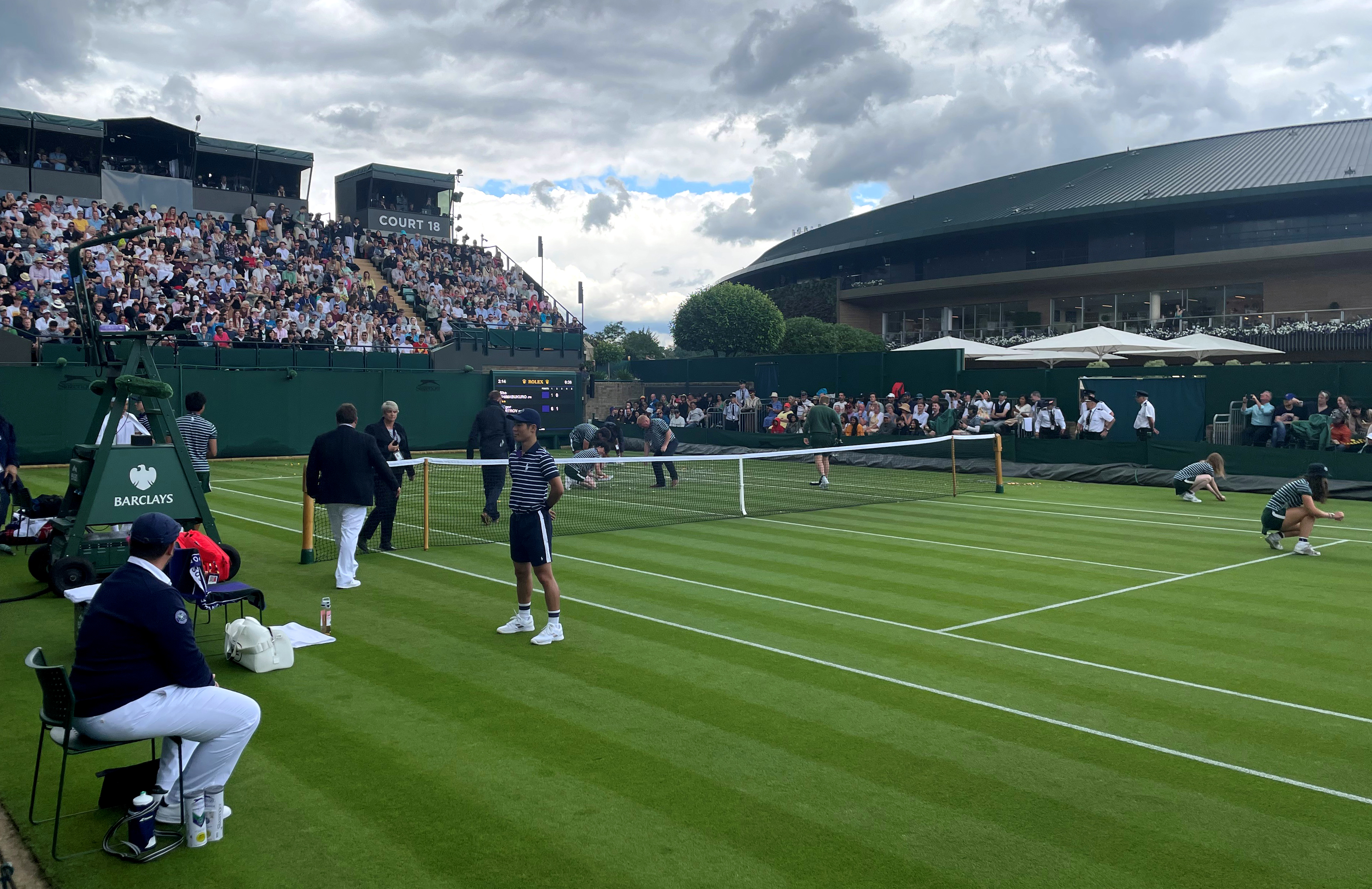 Ground staff clear orange confetti from Court 18