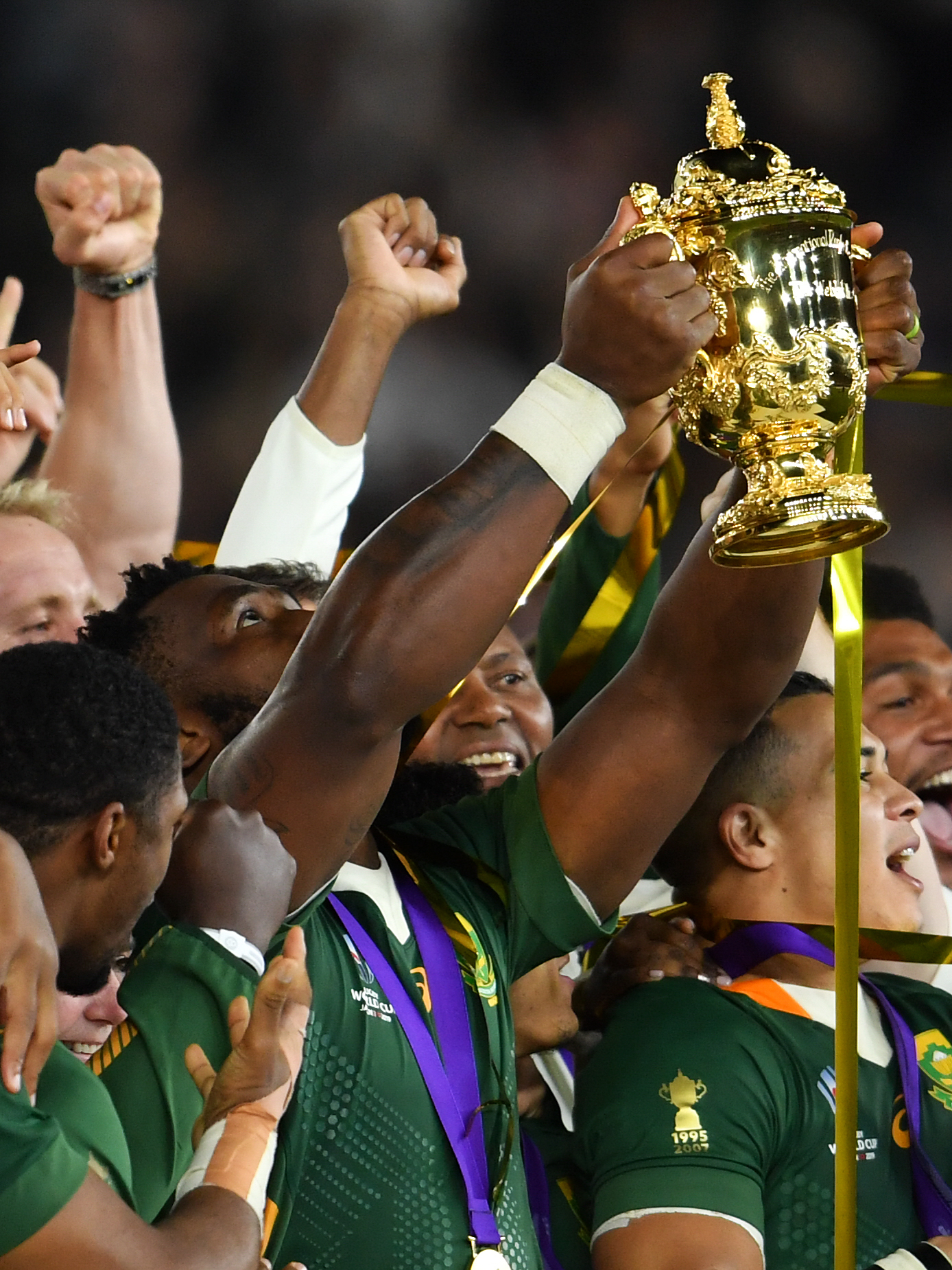 South Africa captain Siya Kolisi, centre left, lifts the trophy after the 2019 World Cup final