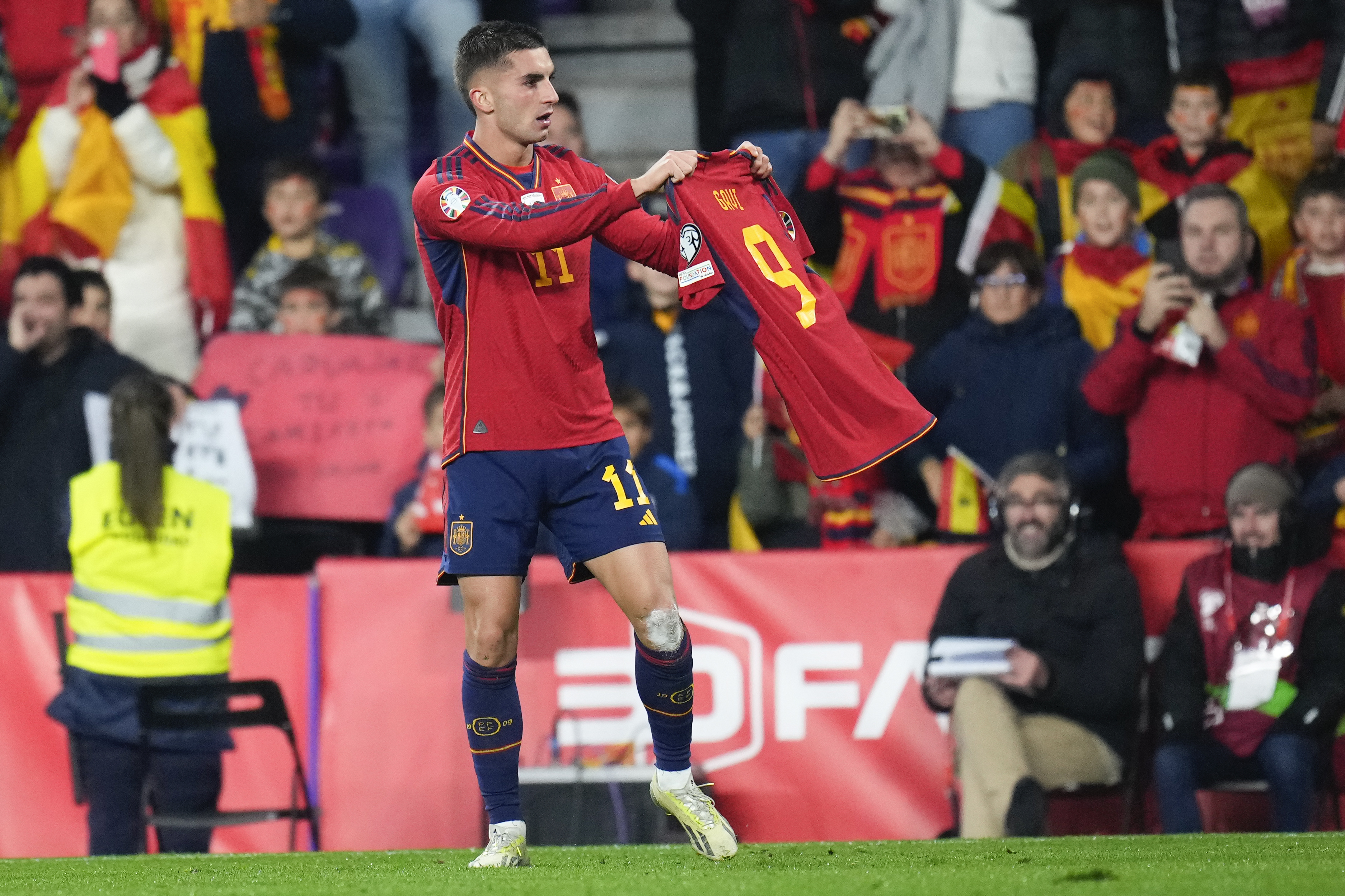 Ferran Torres holds up team-mate Gavi's shirt after scoring Spain's second goal