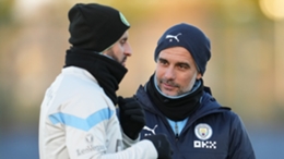 Kyle Walker and Pep Guardiola speak at a Manchester City training session earlier this season