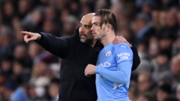 Jack Grealish takes instructions from Manchester City manager Pep Guardiola