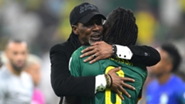 Rigobert Song embraces Andre-Frank Zambo Anguissa after Cameroon's win over Brazil