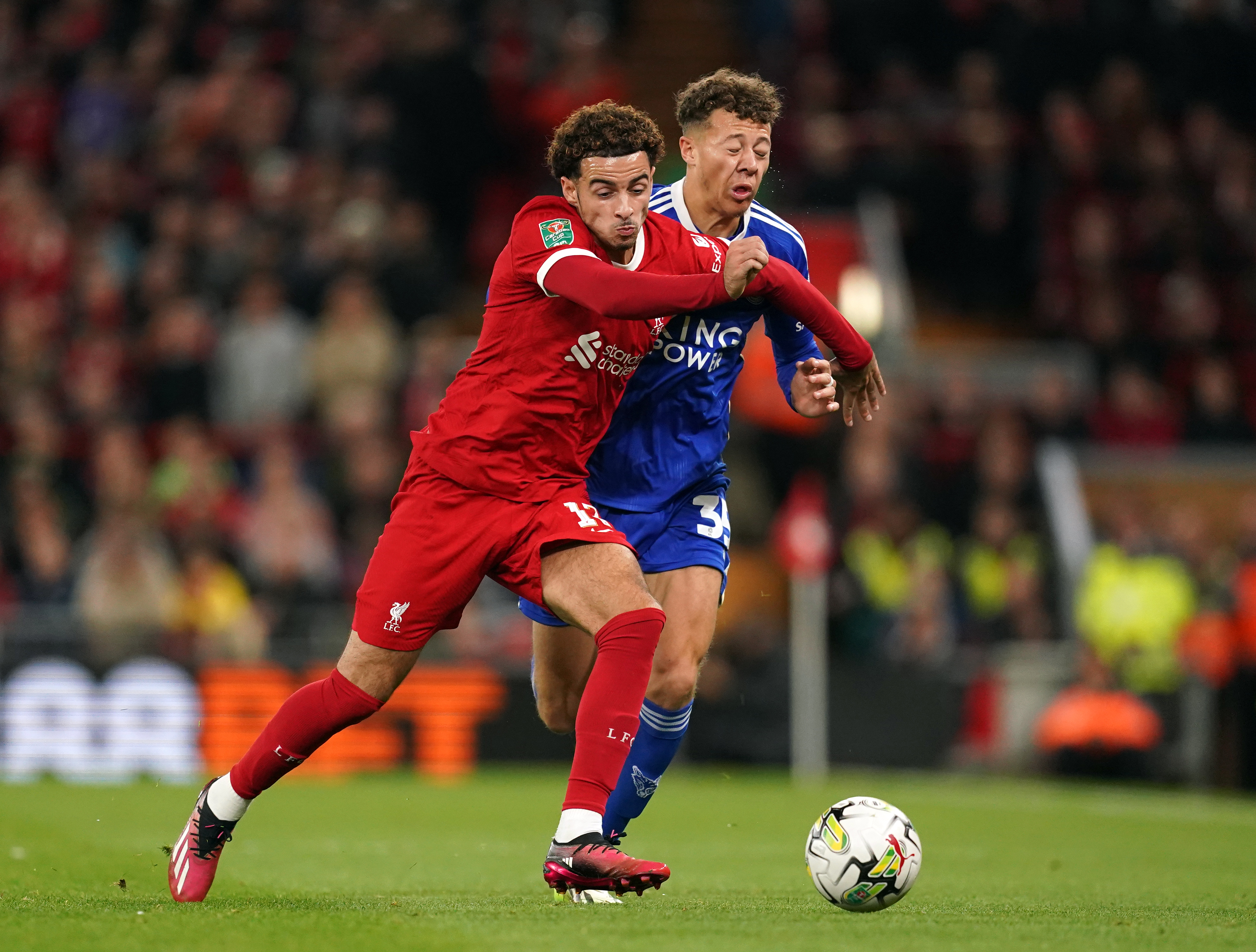 Curtis Jones challenges for the ball