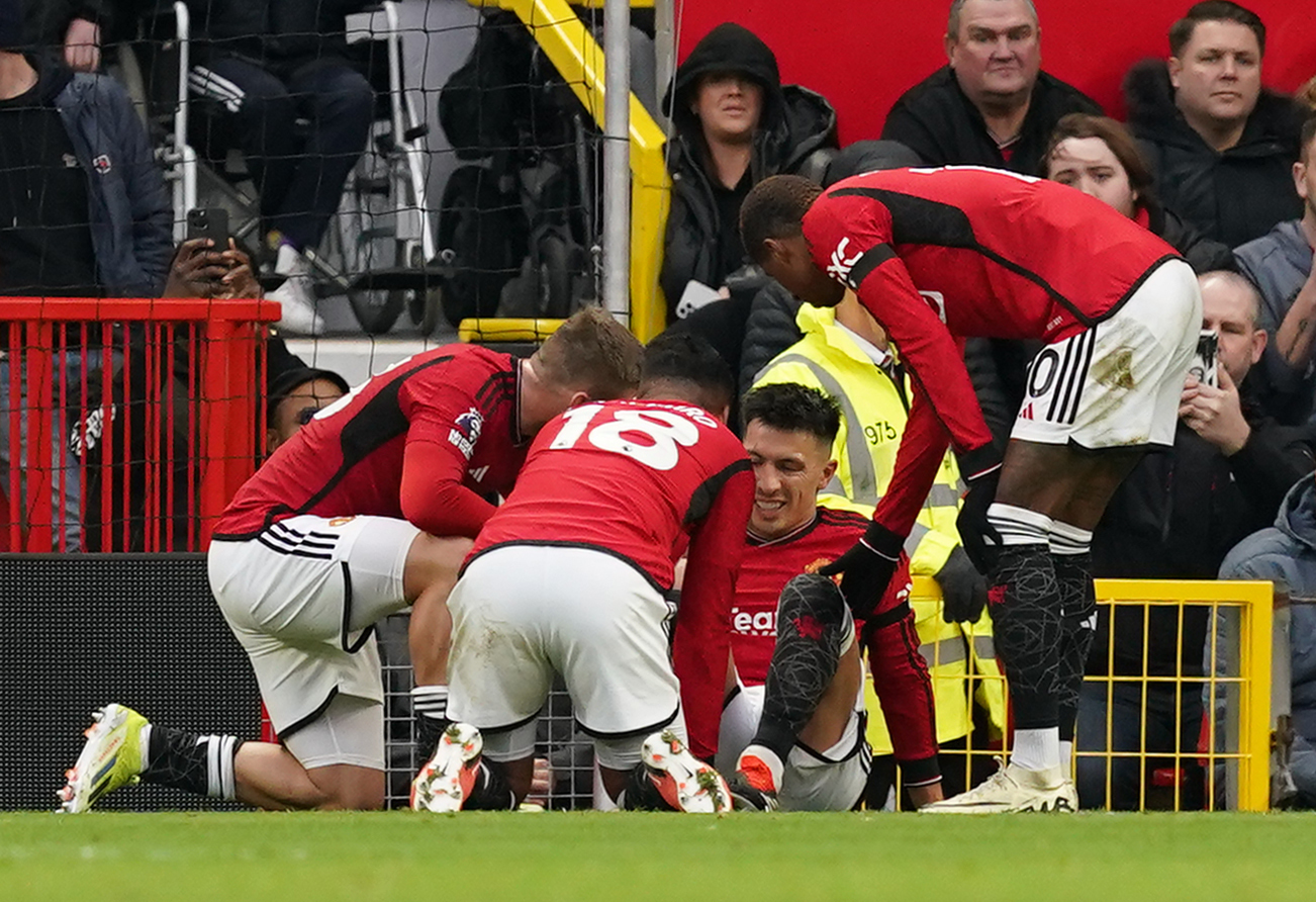Lisandro Martinez is surrounded by team-mates after suffering a knee injury