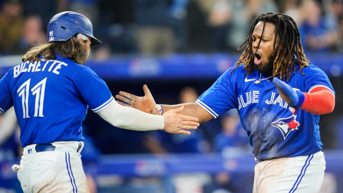 Vladimir Guerrero Jr celebrates with Bo Bichette after the pair come home in the fourth inning against the Yankees to tie the game