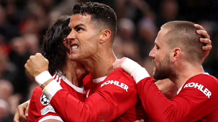 Cristiano Ronaldo of Manchester United celebrates with teammates Luke Shaw and Edinson Cavani after scoring their side's third goal during the UEFA Champions League group F match between Manchester United and Atalanta at Old Trafford