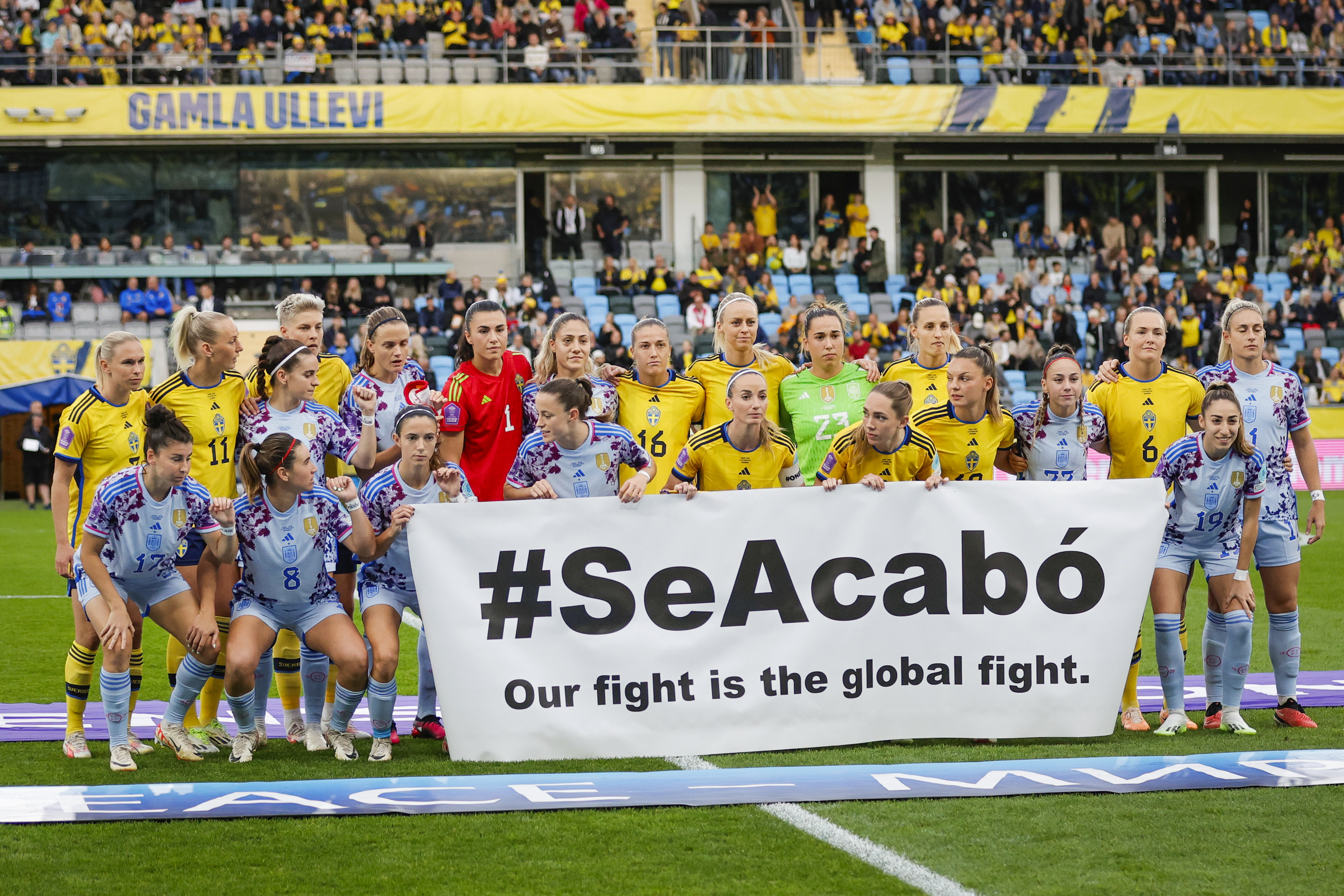 Spain and Sweden players hold a banner reading ‘#SeAcabó – Our fight is the global fight’ before their recent Nations League match