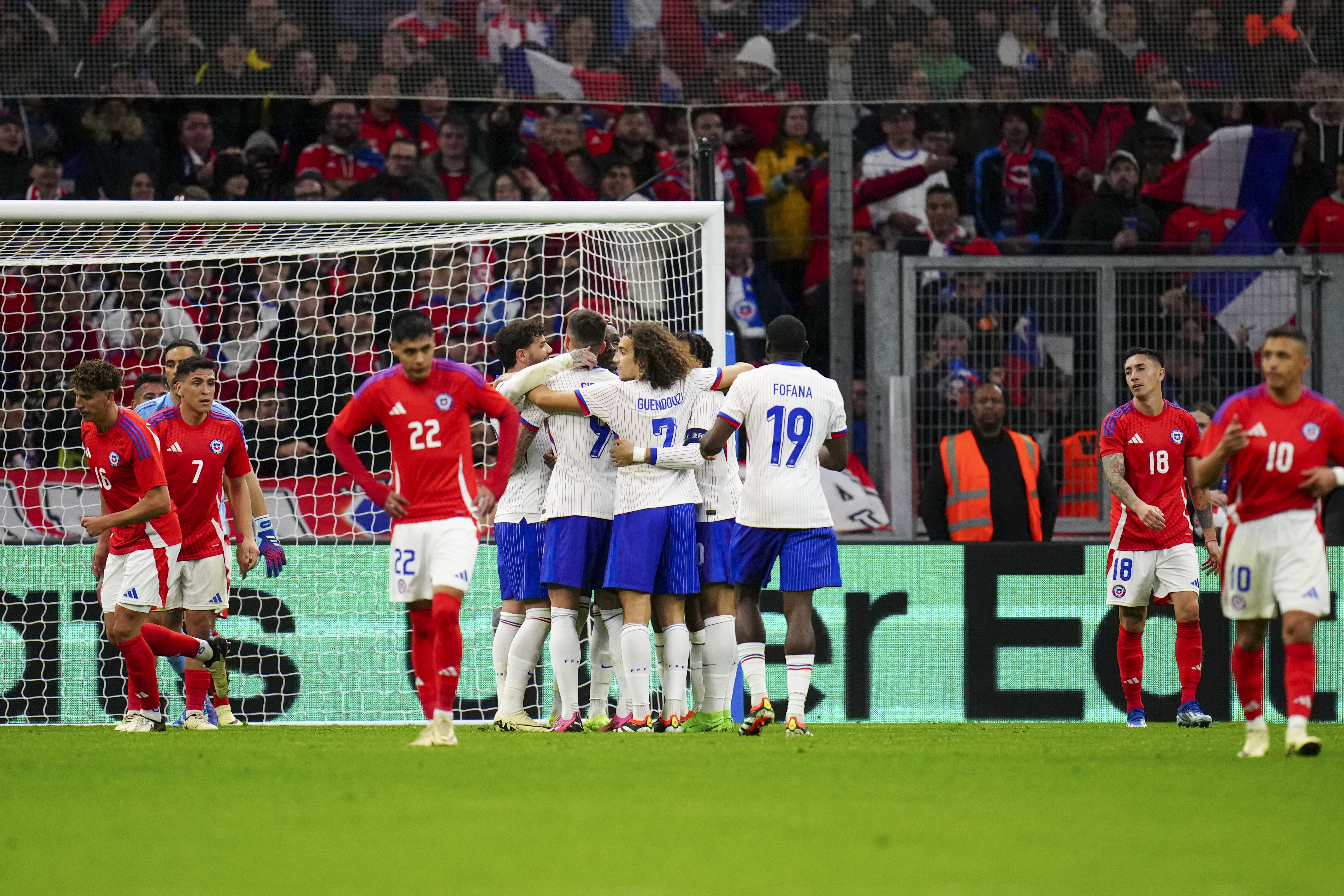 Olivier Giroud is mobbed by his team-mates after scoring France's third goal
