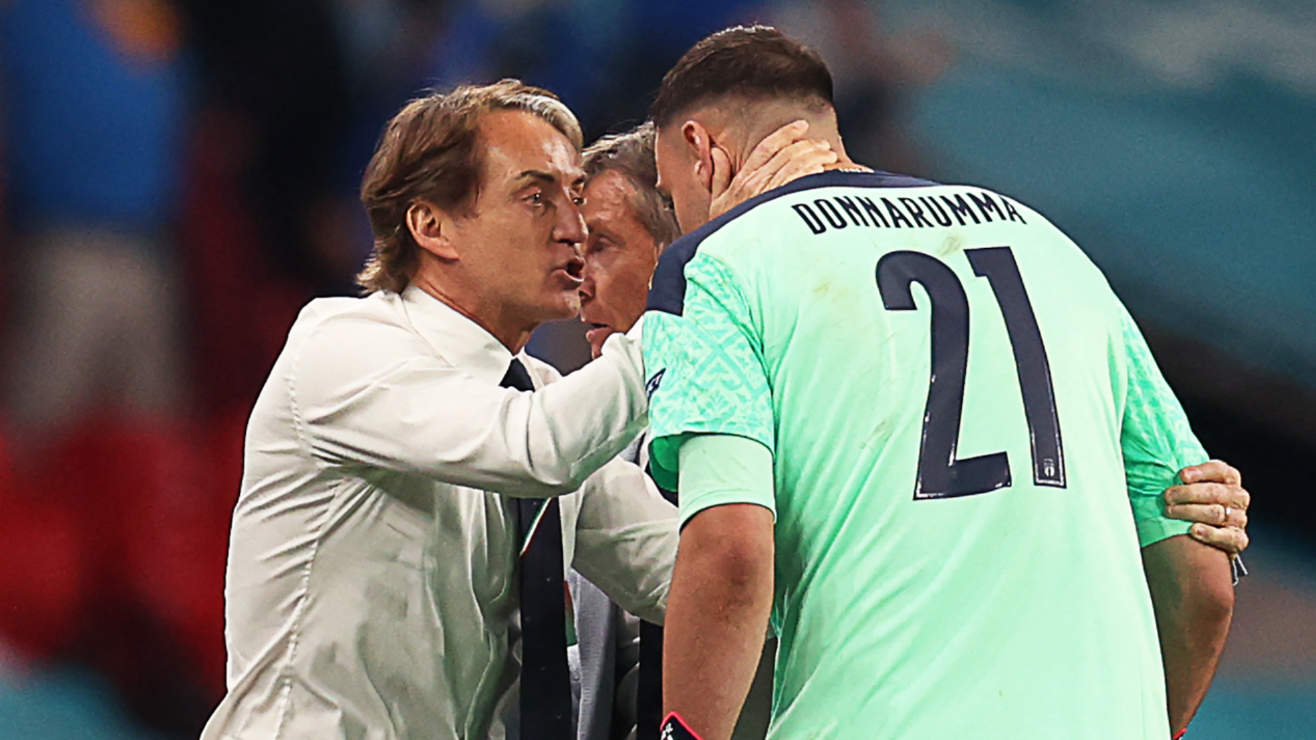 Italy's coach Roberto Mancini (L) celebrates with Italy's goalkeeper Gianluigi Donnarumma