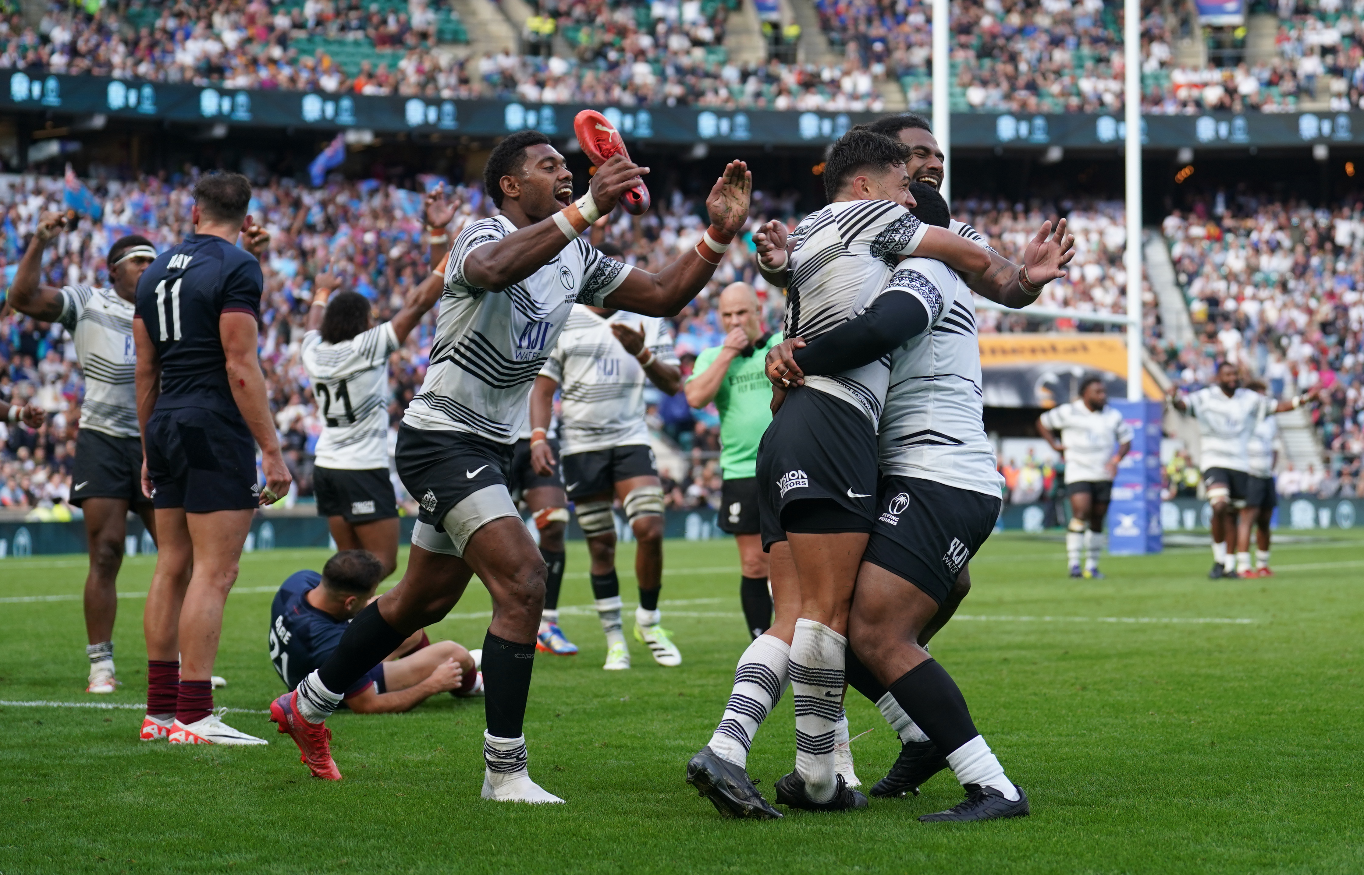 Fiji players celebrate the final whistle after defeating England at Twickenham in August