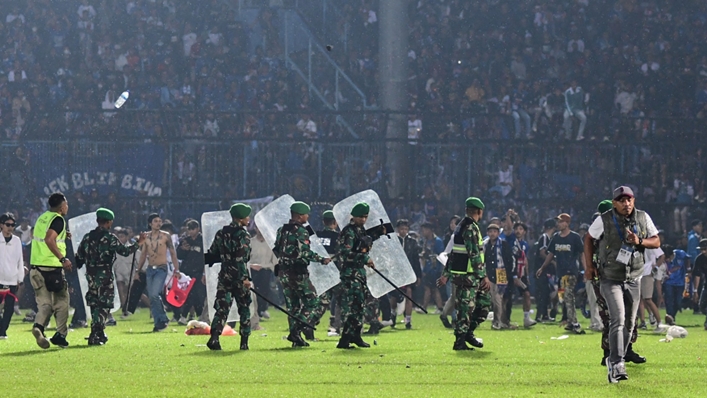 Members of the Indonesian army on the pitch at the Kanjuruhan Stadium