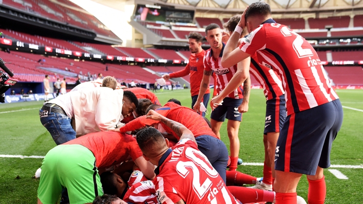 Atletico Madrid players celebrate Luis Suarez's late winner