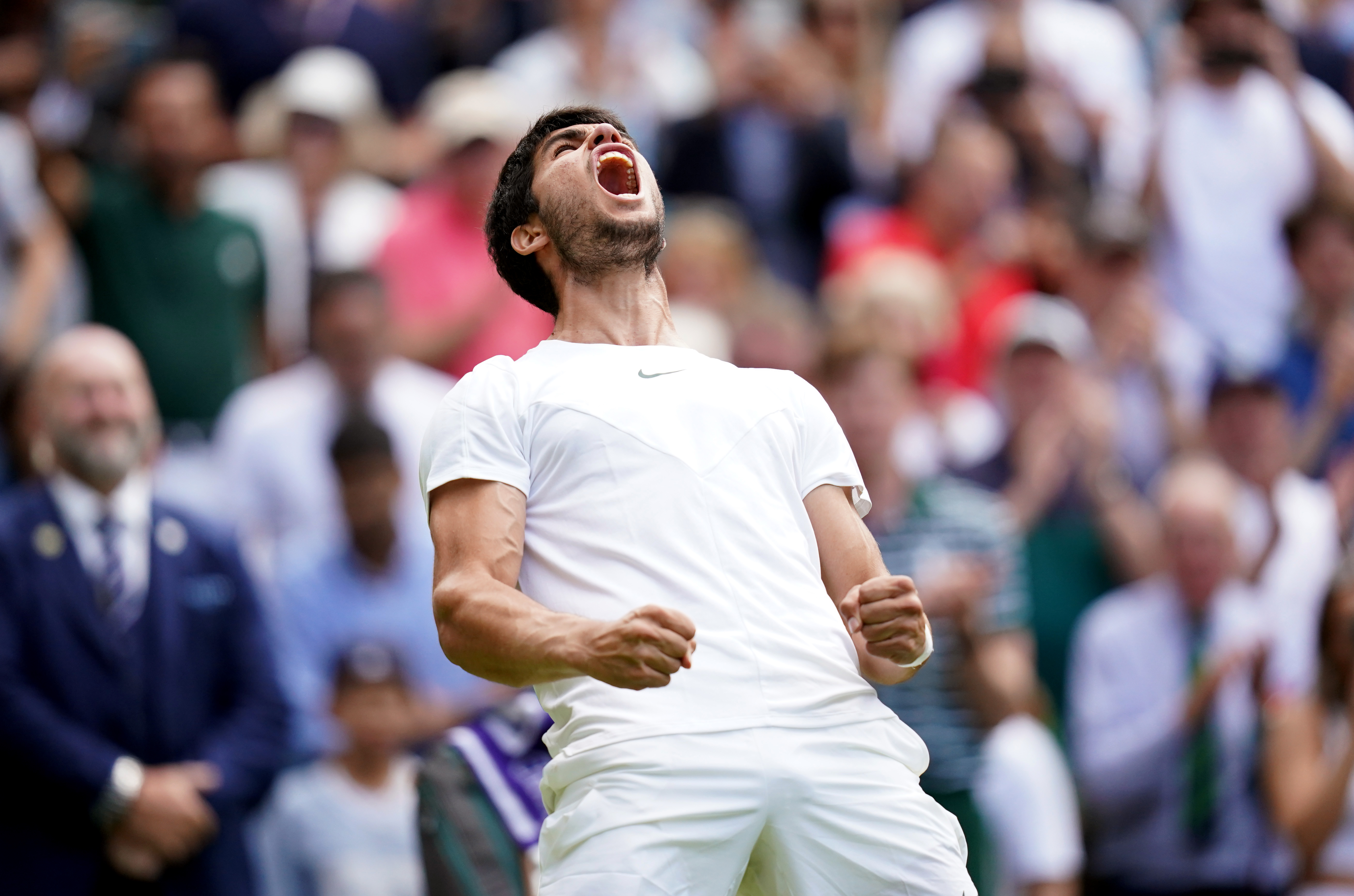 World number one Carlos Alcaraz lets out a roar as he celebrates his straight-sets victory over Holger Rune