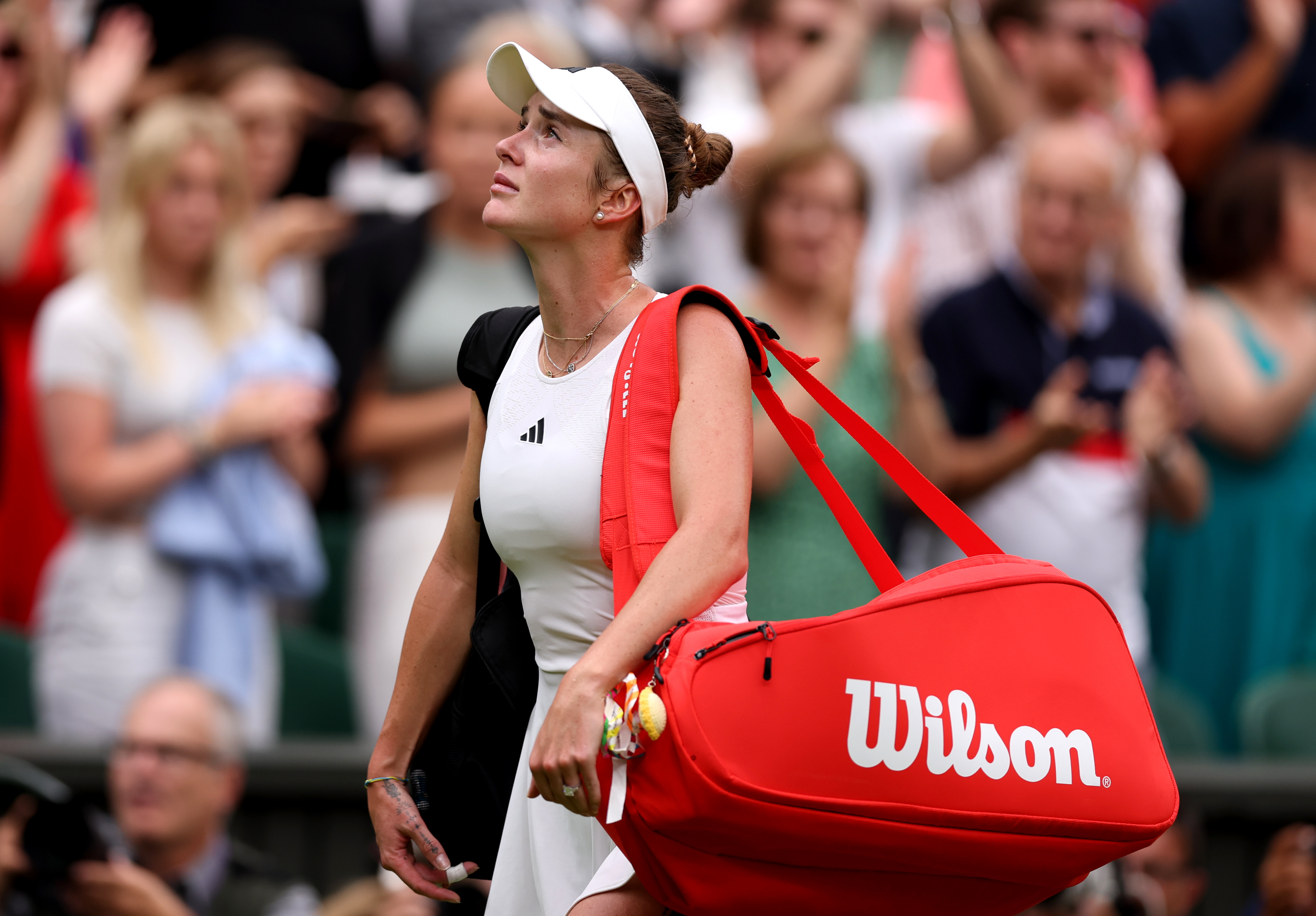 Elina Svitolina walks off Centre Court after her semi-final defeat