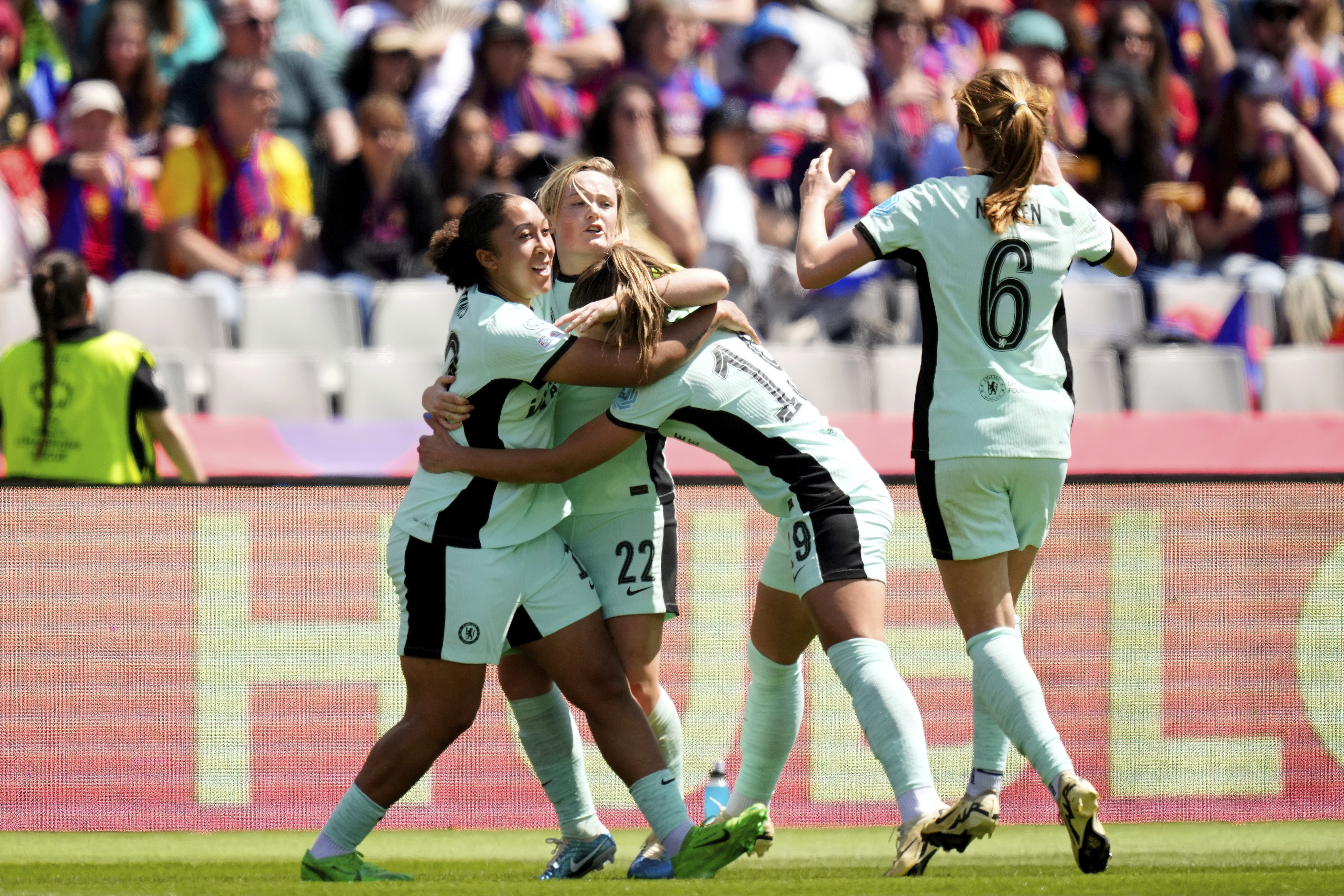 Chelsea’s Erin Cuthbert, (second left) celebrates with her team-mates after scoring at Barcelona