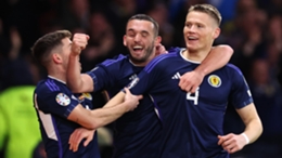 Scott McTominay celebrates with his Scotland team-mates after scoring against Spain