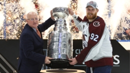 Colorado Avalanche captain Gabriel Landeskog is presented with the Stanley Cup by NHL deputy commissioner Bill Daly