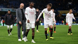 Stefano Pioli (left) and the Milan players leave Stamford Bridge with their heads down after a big loss