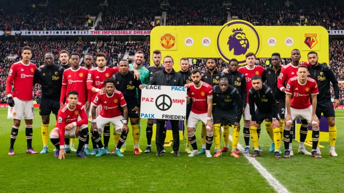 Manchester United and Watford players with a banner of peace