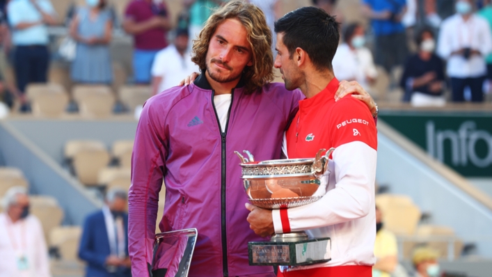Stefanos Tsitsipas (L) is consoled by Novak Djokovic