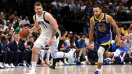Luka Doncic of the Dallas Mavericks brings the ball up court against Stephen Curry of the Golden State Warriors during the second quarter in Game 4 of the 2022 NBA Playoffs