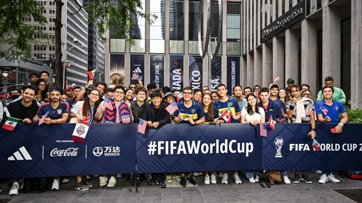 Fans gather outside the site of the World Cup's host city announcement