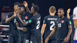 Canada defender Alphonso Davies celebrates with forward Cyle Larin