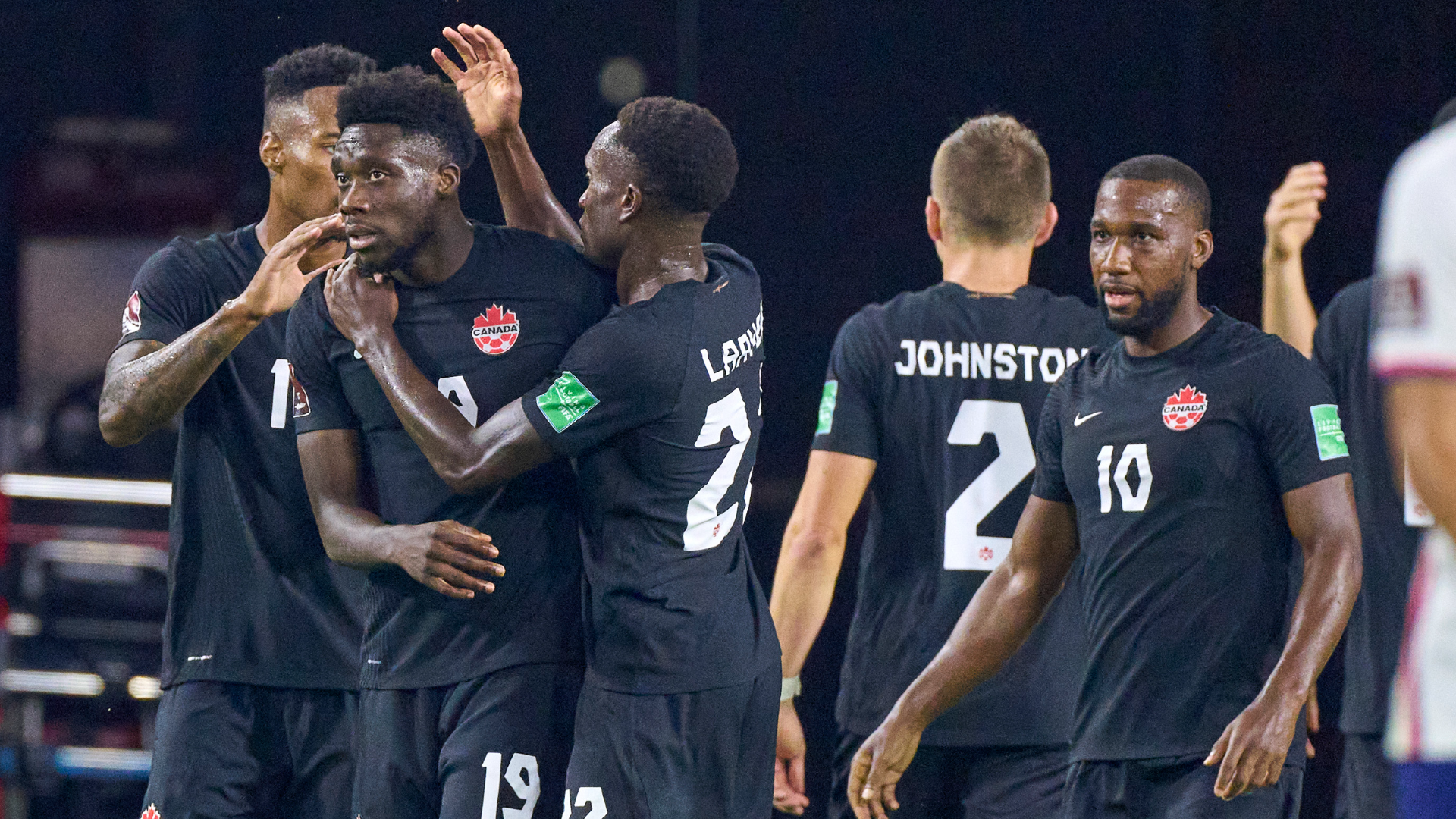 Canada defender Alphonso Davies celebrates with forward Cyle Larin